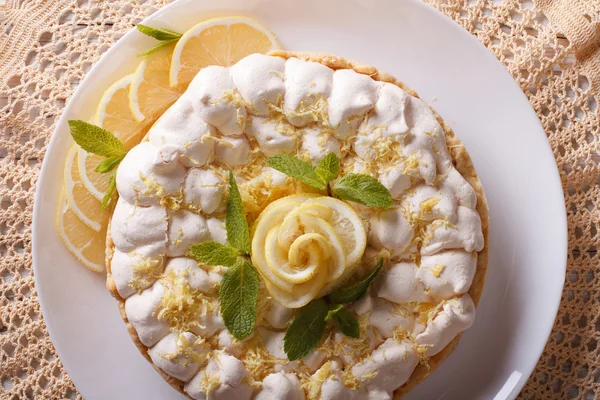 Lemon meringue pie close-up on a plate. Horizontal top view