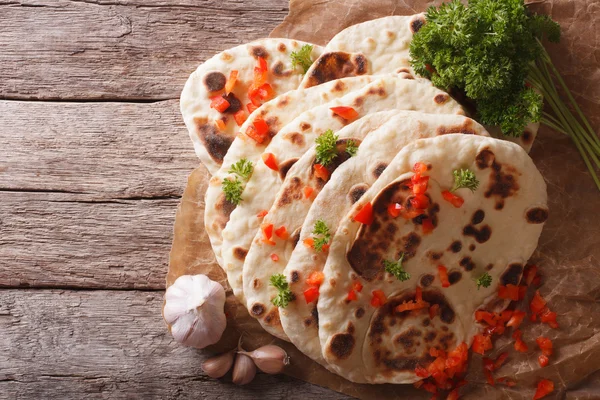 Indian Naan flat bread with garlic and herbs. horizontal top vie