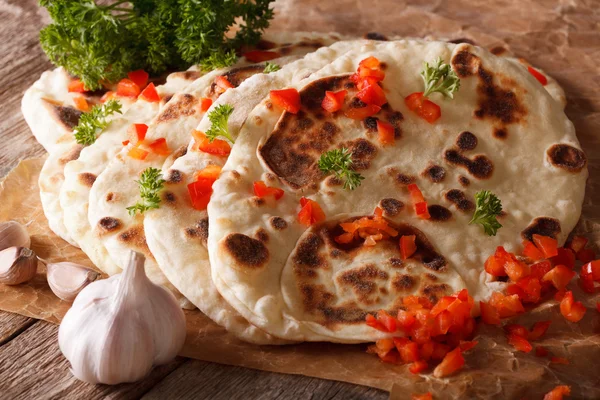 Indian Naan flat bread with garlic and pepper macro. horizontal