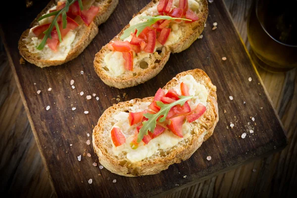 Italian bruschette with tomato and cheese