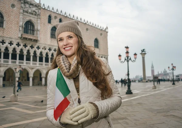 Woman tourist with Italian flag standing on St. Mark\'s Square