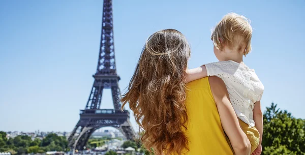 Mother and child looking at Eiffel tower in Paris, France