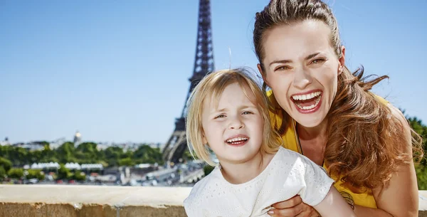 Mother and daughter tourists having fun time in Paris, France