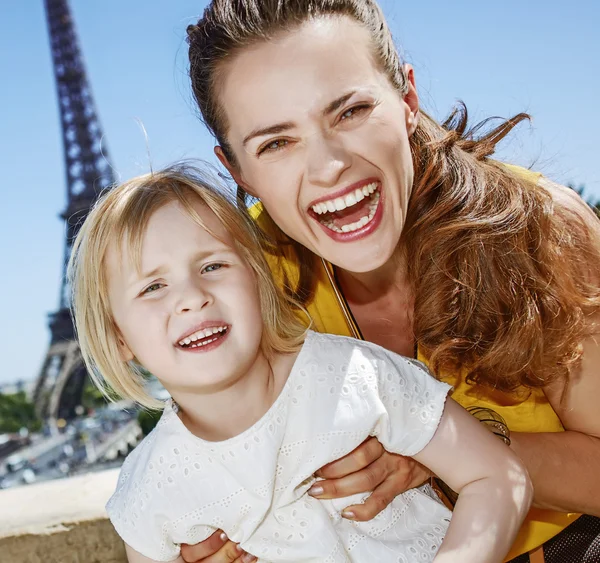 Mother and daughter tourists having fun time in Paris, France