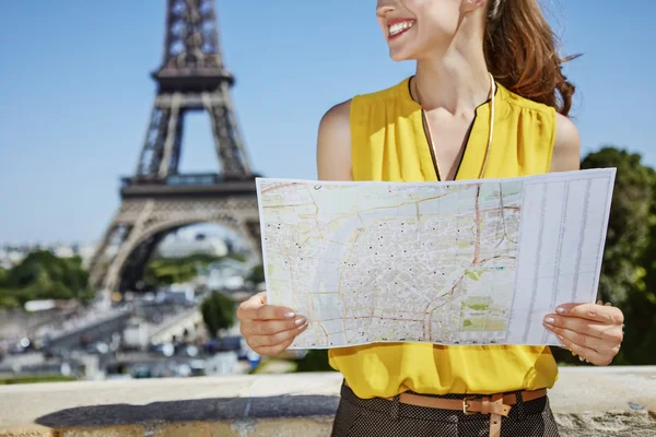 Closeup on happy young woman with map in Paris, France