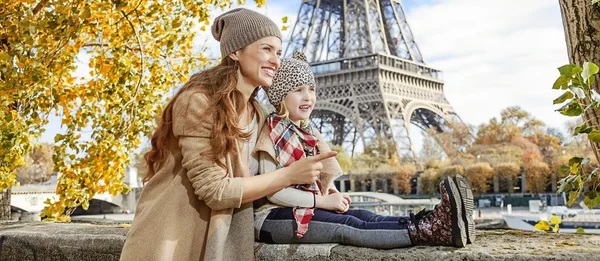Mother and child travelers in Paris pointing on something