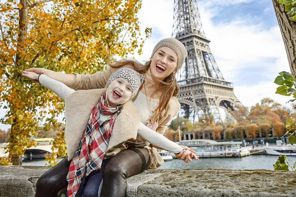 Smiling mother and daughter travellers having fun time in Paris