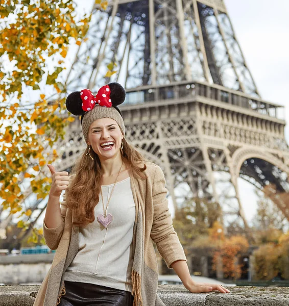 Happy woman wearing Minnie Mouse Ears showing thumbs up, Paris