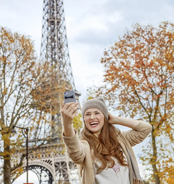 Elegant woman in Paris, France taking selfie with phone