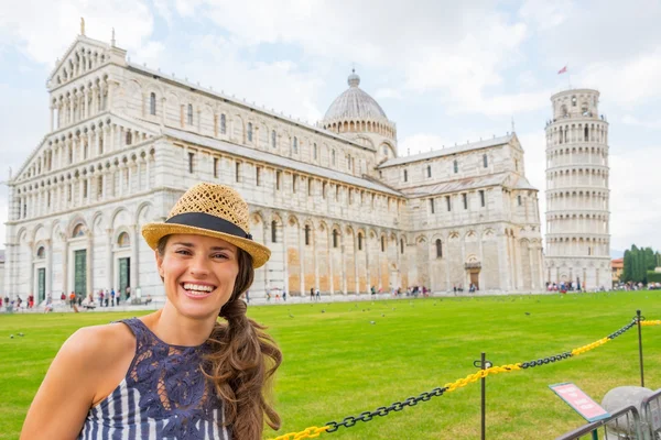 Portrait of happy young woman on piazza dei miracoli, pisa, tusc