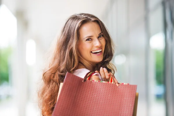 Close-up, over-the-shoulder smiling brown-haired woman shopping
