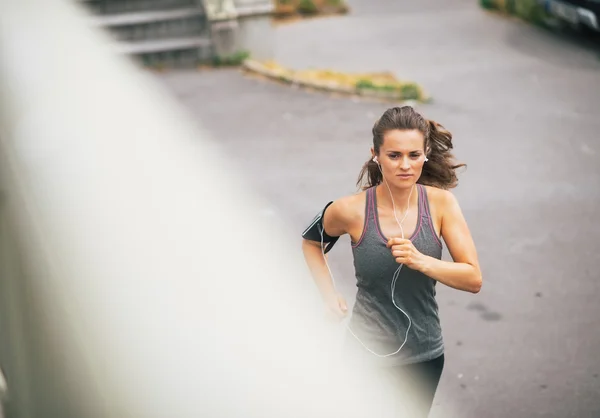 Fitness young woman jogging outdoors in the city