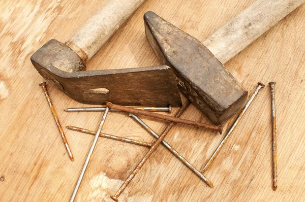 Old hammer, adze and rusty nails