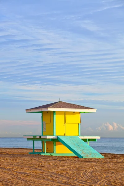 Hollywood Beach Florida, bright yellow lifeguard house at sunrise