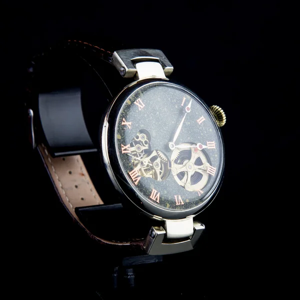 Man's watch on black background. Luxury goods.