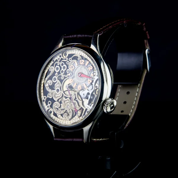 Man\'s watch on black background. Luxury goods.