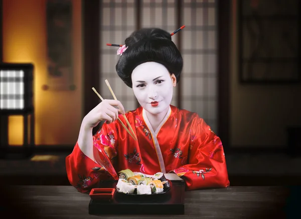 Woman in geisha makeup eating sushi