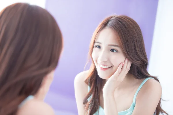 Smiling  woman looking  mirror