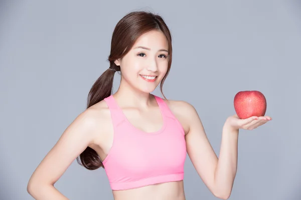 Sport girl with an apple smiling