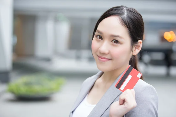 Miling businesswoman holding  credit card