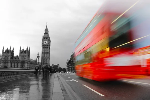 Red bus in motion and Big Ben