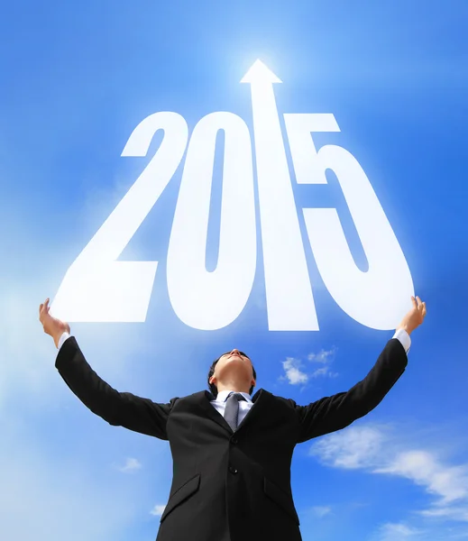 Business man holding 2015 new year imagination