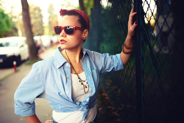Beautiful happy girl with sunglasses on the urban background. Young fancy, funky active people. Outdoors portrait