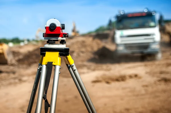 Surveyor engineering equipment with theodolite at highway infrastructure construction site
