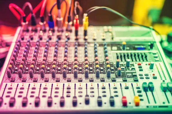 Colorful details of music mixer, buttons on equipment in audio recording studio or nightclub