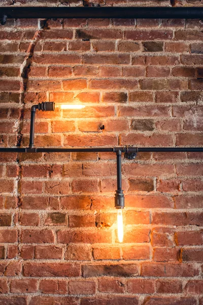 Home decoration walls with lamps, pipes and bricks. Old and vintage looking wall, interior design