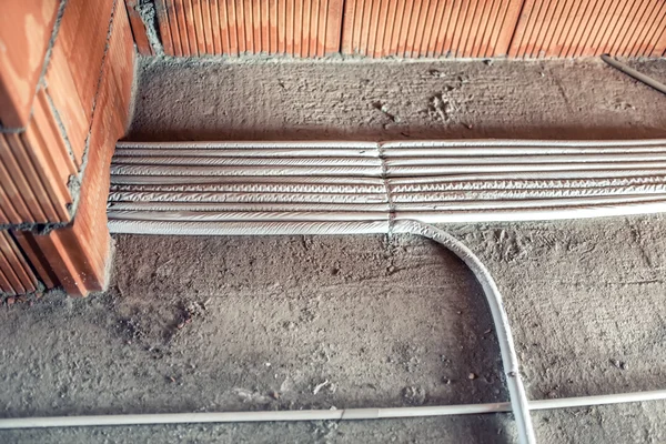 Pipes and heating system at house construction site. floor heating system, the collector and tools