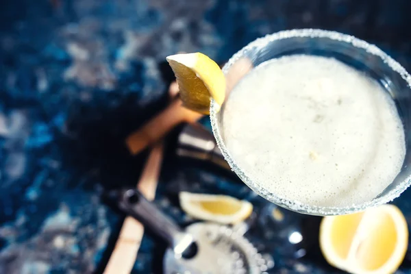 Close-up view of margarita cocktail. Details of fancy beverage on metal background