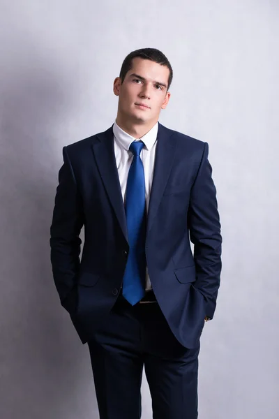 A handsome young man smiling pretty brunette in a dark business suit. Business portrait. business style. office. on a white background