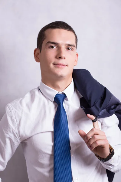 Handsome young handsome brunette man in white shirt and black trousers. Business portrait. business style. office. on a white background