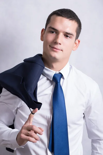 Handsome young handsome brunette man in white shirt and black trousers. Business portrait. business style. office. on a white background