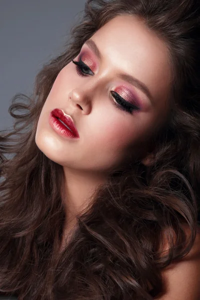 Portrait of a young woman, close-up, bright makeup, eye shadow.