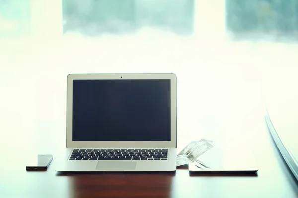 Business Technologies. Workplace with open laptop on modern wooden desk.