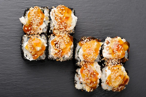 Set of yummy sushi rolls with cream cheese and caramel sauce