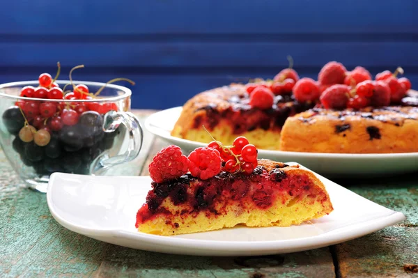Homemade upside down cake with raspberries served with fresh currant