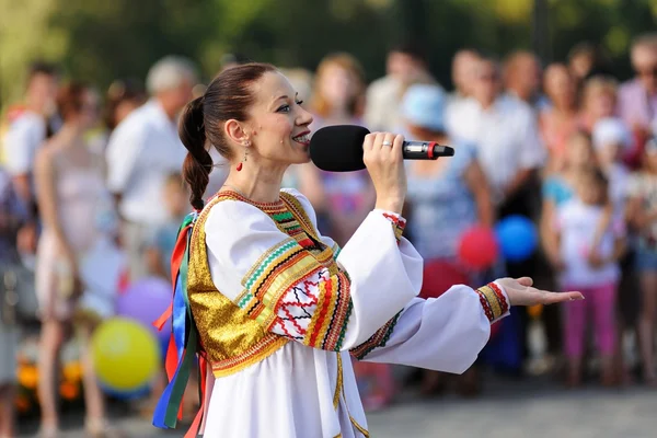 Orel, Russia - August 05, 2016: Orel city day. Girl in Russian dress with microphone