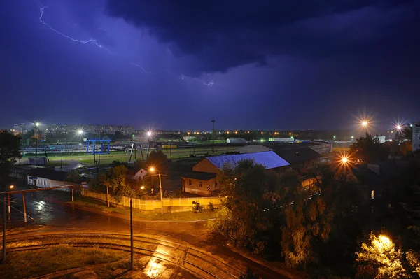 Black cloud and lightning at night over railway cargo yard