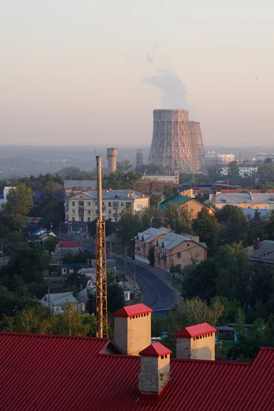 City sunrise landscape with steam-pipes in Russia