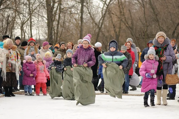 Sack-race during winter Maslenitsa carnival in Russia