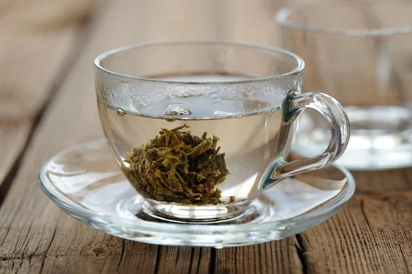 Pressed green tea brewed in glass teacup
