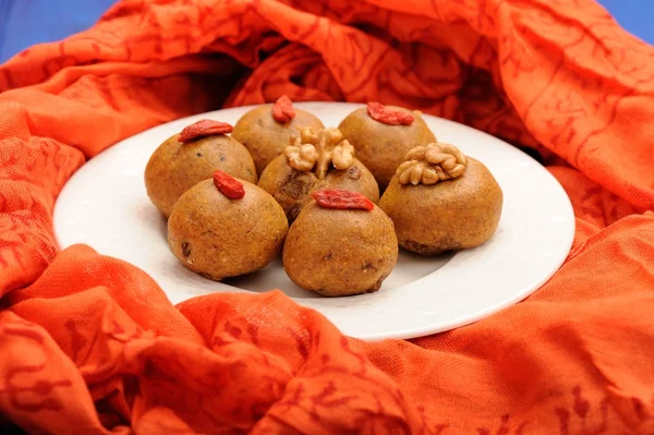 Besan laddu, handmade vegan sweets with wallnuts and goji berrie