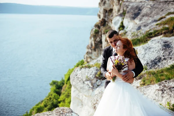 Wedding couple staying over beautiful landscape
