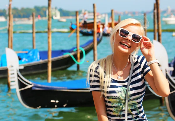 Happy Tourist and Gondolas in Venice, Italy. Cheerful Blonde