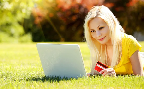 Online Shopping. Blonde Girl with Laptop using Credit Card