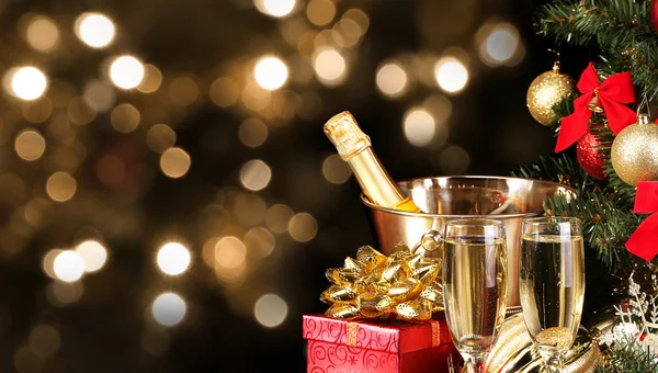 Christmas or New Year\'s Eve. Champagne and Presents over Black