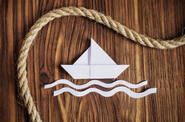 Travel concept with a white paper boat